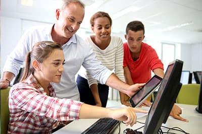 Group of people around a computer
