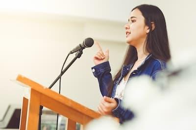 woman standing at podium with microphone